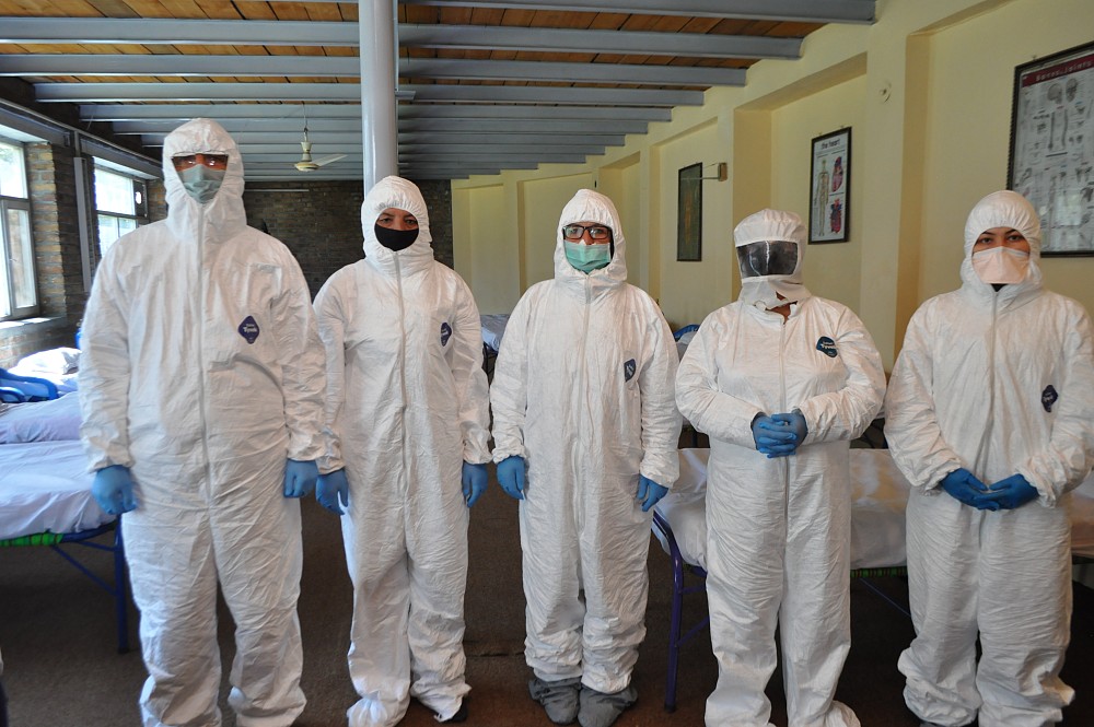 MDC Polyclinic staff in protective suits and with facial protection.